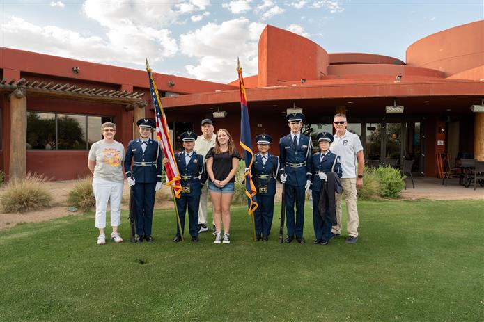  An image of the Chandler High School ROTC standing on a golf course with dignitaries.